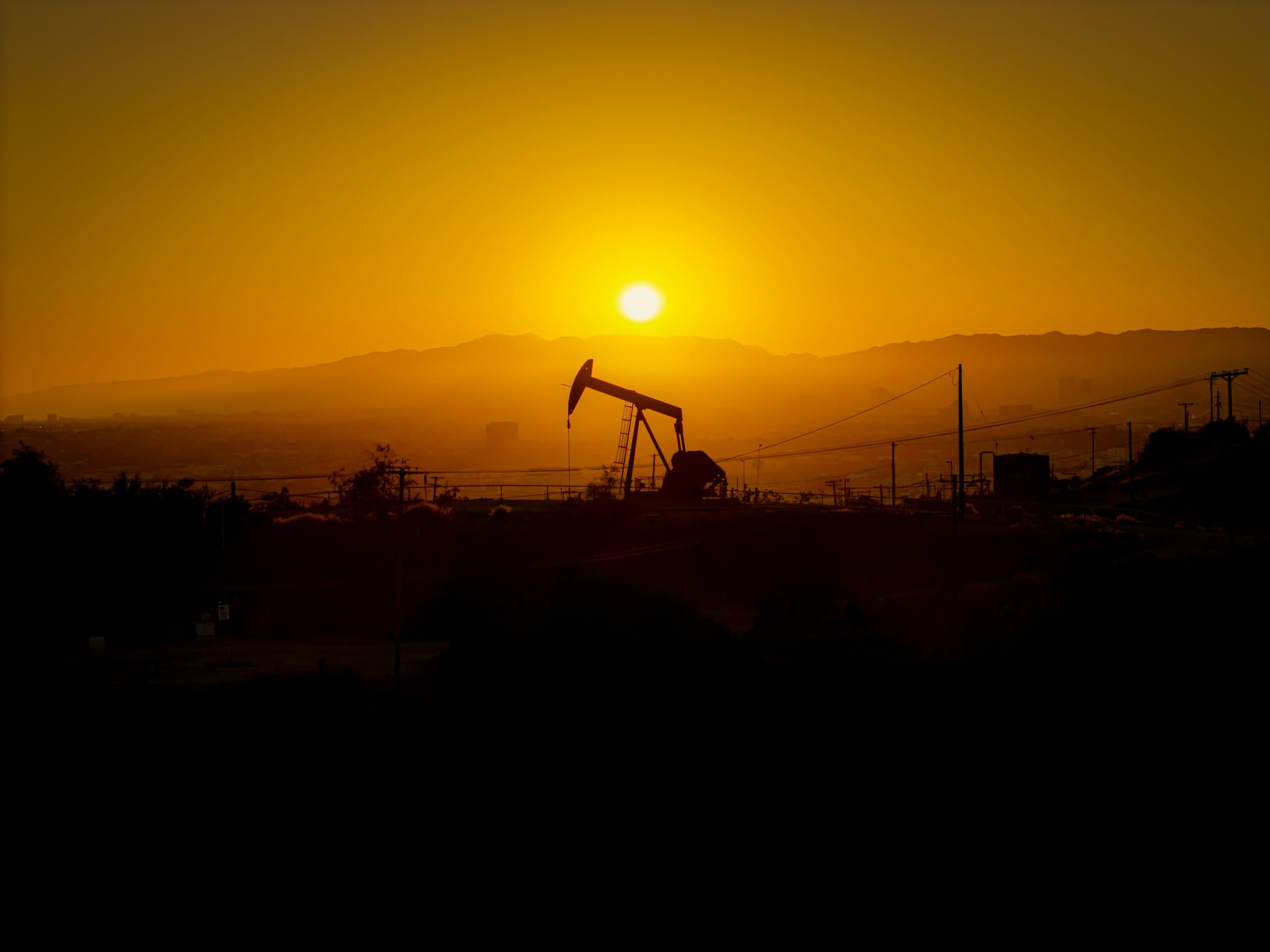 Pumpjack silhouetted against an Alberta sunset