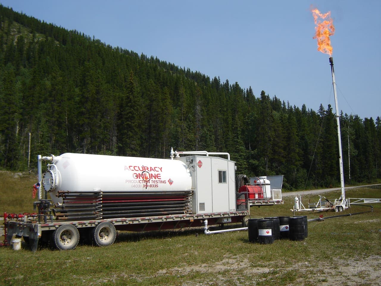 Accuracy Online PT 105 mobile separator on location with free-standing flare stack lit